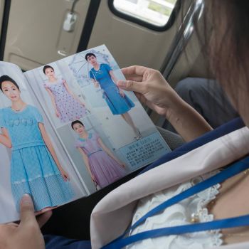 One of the North Korean tour guides reading a fashion catalogue. <a href="https://www.facebook.com/dprk360/photos/a.247847015339134.1073741855.211159445674558/412163502240817/?type=3&theater" target="_blank">Original photo</a> north korea fashion catalogue